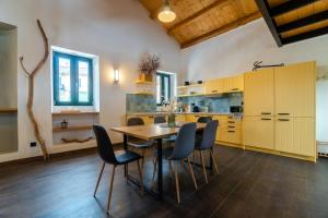 uma cozinha com uma mesa de madeira e cadeiras em Corfu Pigeon Nest em Corfu Town