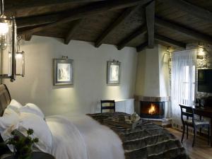 a bedroom with a large bed and a fireplace at Villa Vager in Levidi