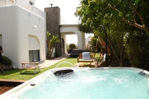 a hot tub in a yard with a fountain at Nirvana Maayan Baruh in Ma‘yan Barukh