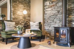 a fireplace in a living room with a stove at Borrowdale Gates Hotel in Keswick