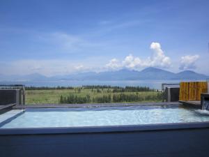 a swimming pool with a view of a lake at Azumaya Hotel Da Nang in Danang