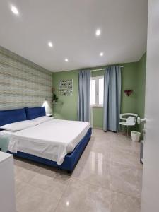 MARGHERITA BOUTIQUE ROOMS في مارغريتا دي سافويا: غرفة نوم بسرير كبير وكرسي