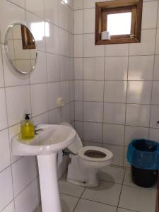 a bathroom with a toilet and a sink and a mirror at Recanto do Vale Glamping in Pomerode