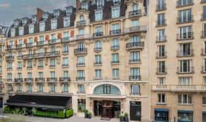 a large building with windows and balconies at Hôtel Pont Royal Paris in Paris