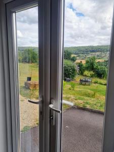 a sliding glass door with a view of a field at No.2 Bloom Apartments, Bath in Bath