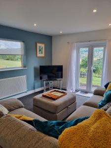 a living room with two couches and a flat screen tv at No.2 Bloom Apartments, Bath in Bath