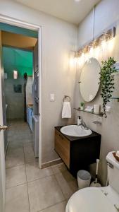 a bathroom with a sink and a toilet and a mirror at Villas at Chalet De Buye in Cabo Rojo