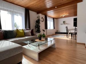 a living room with a couch and a table at Ferienhaus Schwangau in Schwangau +44 photos