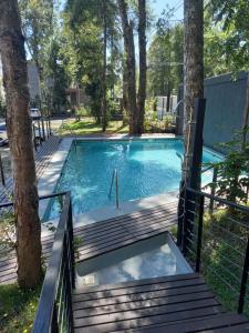 a swimming pool with a deck and stairs at Bello Departamento privado 2 personas,Pucon in Pucón