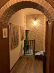 a hallway with an archway in a building at Pirola Music Ranch Guest House B&B in Romano di Lombardia