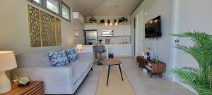 a living room with a couch and a kitchen at Villas at Chalet De Buye in Cabo Rojo