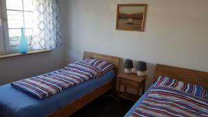 Ein Bett oder Betten in einem Zimmer der Unterkunft Ferienwohnungen Brasse