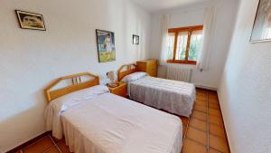 a room with two beds and a window at Villa Desamparados-Murcia Holiday Rentals Property in Torre-Pacheco +19 photos