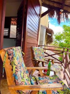 a pair of chairs sitting on the porch of a house at Residencial Bem-te-vi in Jericoacoara