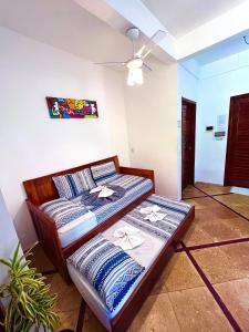a room with a bed and a table in it at Residencial Bem-te-vi in Jericoacoara