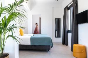 a bedroom with a bed and a potted plant at PAME Wild in Athens