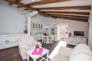 a living room with two couches and a table at Old Town Apartment Paulina in Dubrovnik