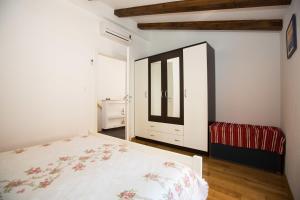 a bedroom with a bed and a large window at Old Town Apartment Paulina in Dubrovnik