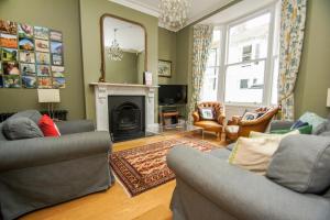 a living room with two couches and a fireplace at Sudeley House - by Brighton Holiday Lets in Brighton & Hove