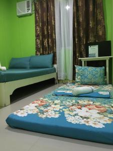 a bedroom with two beds and a couch at Twin AP Homes in Boracay