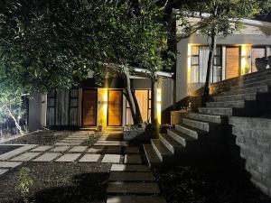 a house with a set of stairs leading to the front door at InstaHomes by Tru - Garden Suites in Blantyre