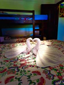 two swans made to look like hearts on a bed at Residencial Bem-te-vi in Jericoacoara