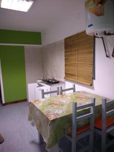 a kitchen with a table and chairs in a room at container in San Gerónimo