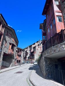 an empty street in an old city with buildings at Pleta 214 in Soldeu