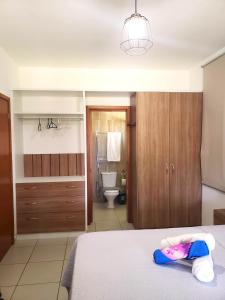 a bedroom with a bed and a bathroom with a toilet at Bangalô Eco Residence Flecheiras in Flecheiras