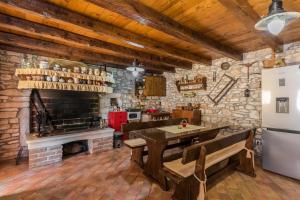 a kitchen with a table and a refrigerator at Beautiful villa Natura with pool in Labin in Labin