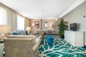 a living room with two couches and a tv at Holiday Inn Porto Gaia, an IHG Hotel in Vila Nova de Gaia