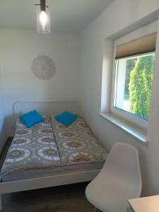 A bed or beds in a room at Domki apartamentowe BALIA
