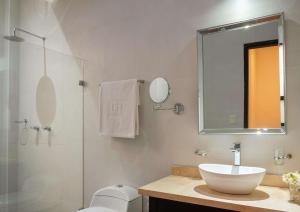 a bathroom with a sink and a glass shower at NH Boulevard del Río Cali in Cali