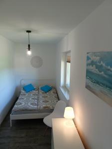 A bed or beds in a room at Domki apartamentowe BALIA