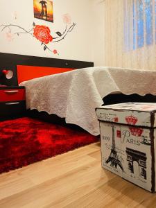 a bedroom with a bed and a red rug at Casa Iris in Iaşi