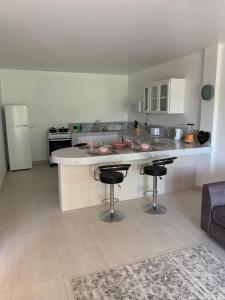 a kitchen with a counter and two bar stools at Kay Nou Apartments in Gros Islet