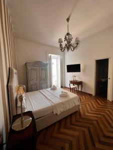 a bedroom with a bed and a chandelier at Villa Valminuta in Ercolano