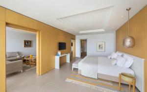 a bedroom with a bed and a living room at Royal Azur Thalassa in Hammamet