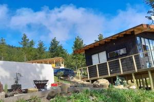 a house under construction with a car parked in front at Tinyhouse Boyeruca Lodge. Maravillosas vistas de Bosque, Mar y Cielo in Vichuquén