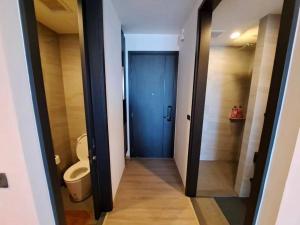 a bathroom with a toilet and a blue door at Downtown Chic Condo High Floor #E59 in Pattaya Central