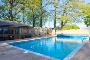 a swimming pool in a yard next to a house at Mousehole in Mawnan