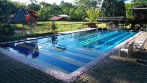 a large swimming pool with blue water at Grand Selva Lodge & Tours in Tena