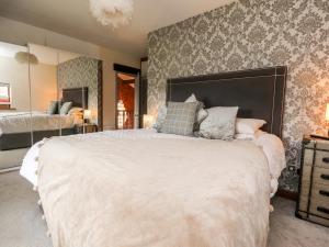 a bedroom with a large bed and a wall at Noah's Barn in Poulton le Fylde