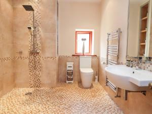 a bathroom with a sink and a tub and a toilet at Noah's Barn in Poulton le Fylde +43 photos