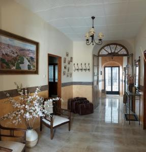 a living room with a couch and a table at La Plazuela, casa andaluza con patio. in Montoro