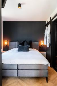 a bedroom with a large bed with black walls at Gîte81 in Reeuwijk