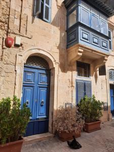 a blue door on the side of a building at Nr65 Valletta Portview Apartment in Valletta