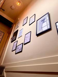 a wall of pictures on a wall in a room at Private Loft Country Hideaway in Shifnal