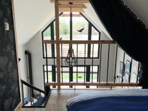 a bedroom with a large window in a attic at Stark House Gallery in Borsk