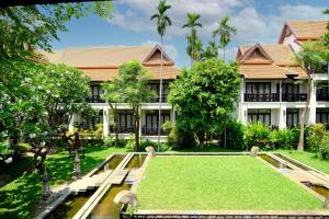 a house with a lawn in front of it at Bodhi Serene, Chiang Mai - SHA Extra Plus in Chiang Mai
